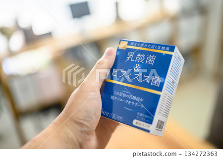 Lactic acid bacteria and bifidobacteria supplements held in hand 134272363