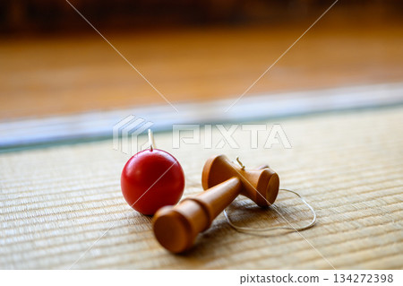 Kendama and red ball on tatami mat, traditional Japanese still life photography Kendama and red ball on tatami mat, traditional Japanese still life photography 134272398