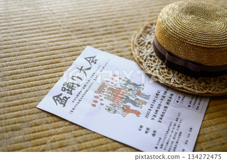 A Bon Odori festival flyer and straw hat placed on a tatami mat A Bon Odori festival flyer and straw hat placed on a tatami mat 134272475