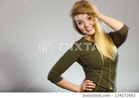 Attractive blonde woman wearing tight green khaki dress 134272662