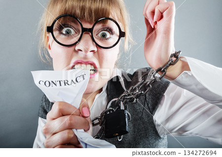 Furious woman with chained hands and contract 134272694
