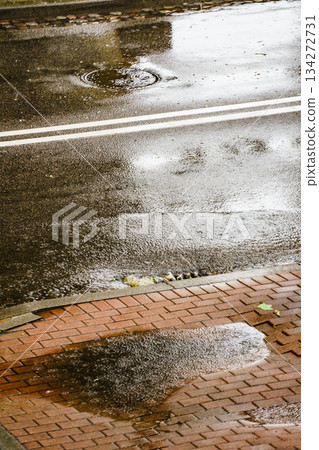 Heavy rain drops falling on city street. Heavy rain drops falling on city street. 134272731