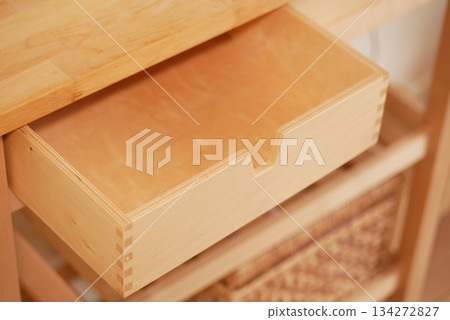 Wooden drawer pulled out from shelf in simple kitchen Wooden drawer pulled out from shelf in simple kitchen 134272827