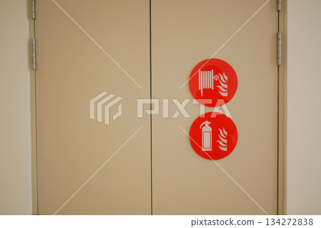 Safety signs on a wall in a building hallway 134272838