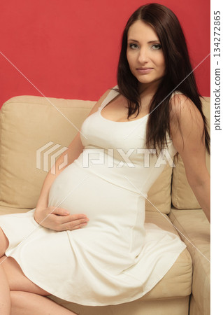 pregnant woman relaxing on sofa 134272865