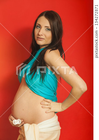 Adult woman showing her pregnant belly Adult woman showing her pregnant belly 134272871