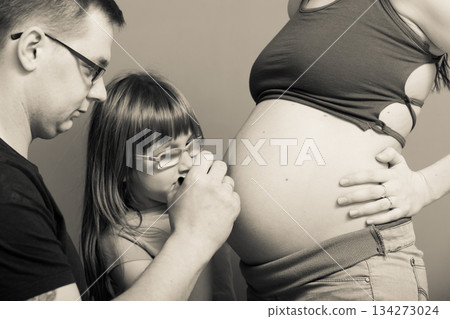 Pregnant woman belly, father drawing on stomach 134273024