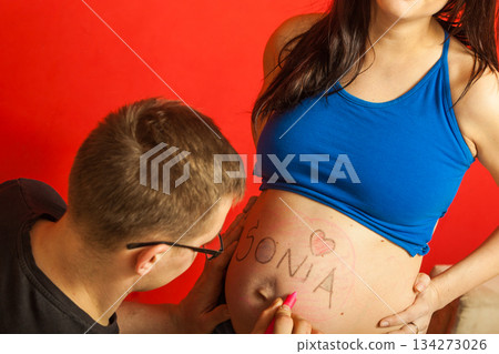Pregnant woman belly, father drawing on it Pregnant woman belly, father drawing on it 134273026