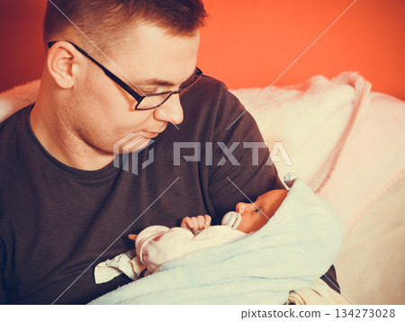 Father holding taking care of newborn baby Father holding taking care of newborn baby 134273028