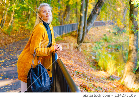 Fashion woman walking in autumn park Fashion woman walking in autumn park 134273109