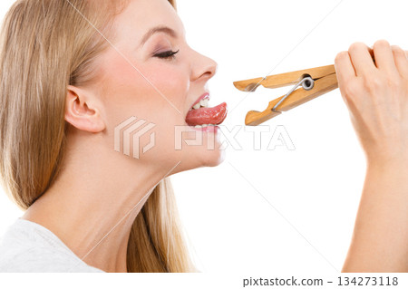 Blonde woman having tongue in clothespin Blonde woman having tongue in clothespin 134273118