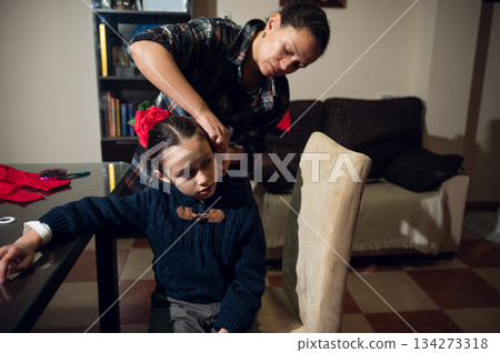 Mother Styles Daughter Hair At Home: Warm Bonding Moment During Christmas Time Mother Styles Daughter Hair At Home: Warm Bonding Moment During Christmas Time 134273318