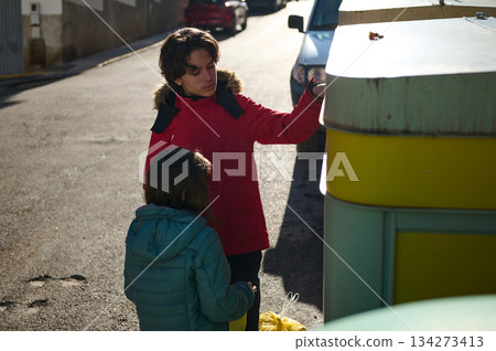 Young Girl In Red Coat Assists Friend At Street Market Stand 134273413
