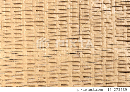 Shredded cardboard creates an abstract corrugated texture for sustainable packaging 134273589