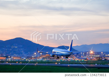 Airport at dusk and landing planes Airport at dusk and landing planes 134273811