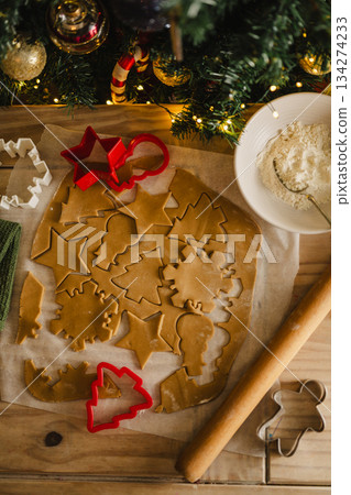 Holiday background. Cooking Christmas gingerbread cookies with cookie cutters on a table, top view, flat lay 134274233