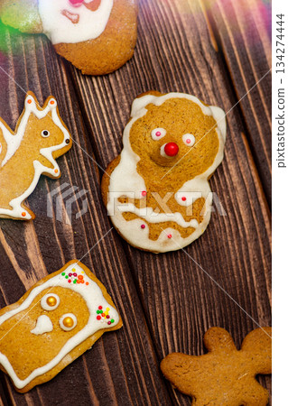Homemade Xmas dessert gingerbread and spices on old wooden background. Holiday gingerbread cookie assortment. Homemade Xmas dessert gingerbread and spices on old wooden background. Holiday gingerbread cookie assortment. 134274444