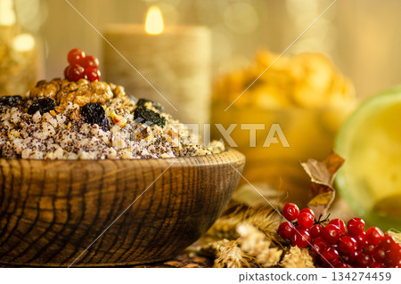 Festive Ukrainian Christmas grain dish with wheat, poppy seeds, walnuts, and dried fruits in rustic bowl. Traditional food composition reflects Ukrainian Festive Ukrainian Christmas grain dish with wheat, poppy seeds, walnuts, and dried fruits in rustic bowl. Traditional food composition reflects Ukrainian 134274459