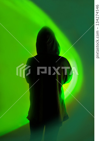 Ability to securely store data on a mobile device. Mystery man with mobile phone on vibrant neon light background. 134274546