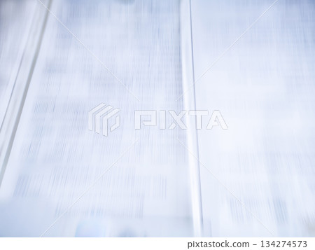 Open book with fictitious text high speed motion blurred background Open book with fictitious text high speed motion blurred background 134274573