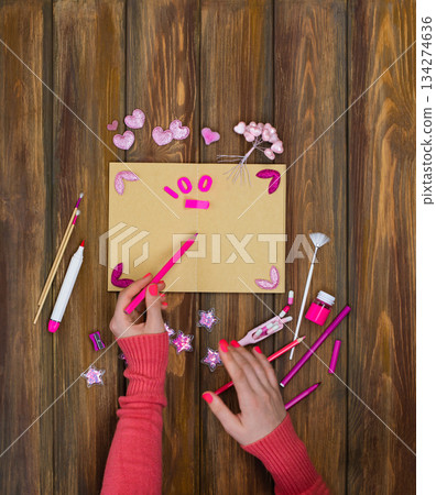 Inspirational workplace and hands holding marker. Artist draws with art markers. Process of painting with a brush markers. Inspirational workplace and hands holding marker. Artist draws with art markers. Process of painting with a brush markers. 134274636
