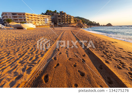 Tracks and footprints on Platja Gran at sunrise, Tossa de Mar, Spain Tracks and footprints on Platja Gran at sunrise, Tossa de Mar, Spain 134275276
