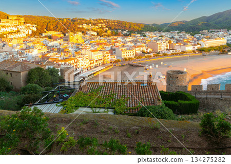 Tossa de Mar beach and town at sunrise, Tossa de Mar, Spain Tossa de Mar beach and town at sunrise, Tossa de Mar, Spain 134275282