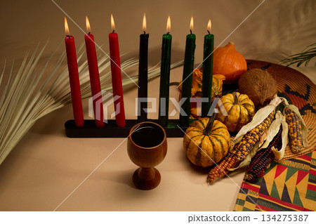 Kwanzaa Celebration Setup. A Kwanzaa display with candles, fruit, and a cup symbolizing unity. 134275387