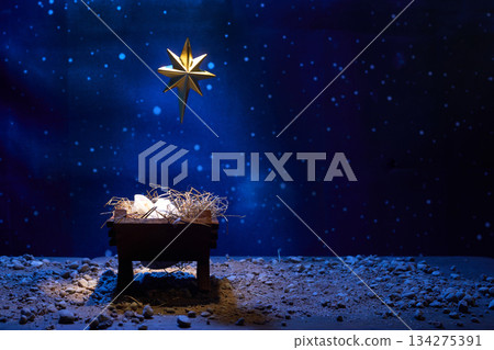 Nativity Scene Star. A glowing star over a manger with a stone backdrop 134275391