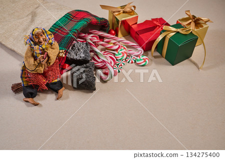 Epiphany Befana's stocking with sweet coal and candy. Italian Epiphany day. Epiphany Befana's stocking with sweet coal and candy. Italian Epiphany day. 134275400