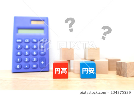 The concept of exchange rate forecasting is shown by blocks comparing strong and weak yen and question marks. The concept of exchange rate forecasting is shown by blocks comparing strong and weak yen and question marks. 134275529