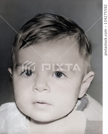 A vintage portrait of an enthusiastic one-year-old girl wearing a bib while eating. Retro photo from 1995. 134275592