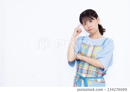 A housewife holding her head in trouble 134276099