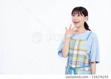 Housewife smiling and surprised Housewife smiling and surprised 134276245