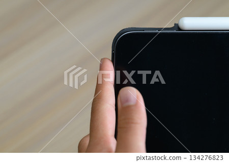 Finger to turn on the tablet 134276823