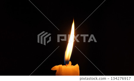 Candle Flickers Through Stormy Darkness, Gentle Flicker Symbolizes Strength In Shadowed Darkness, Wavering Candle Flame Showcases Resilience During Storm And Power Loss Situations 134276917