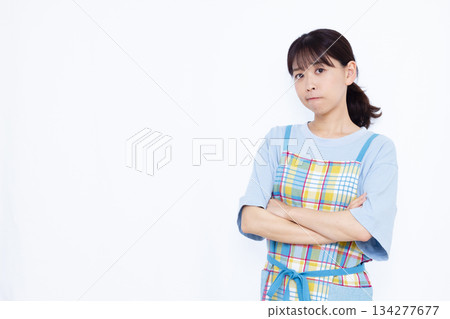 A troubled housewife with her arms crossed 134277677