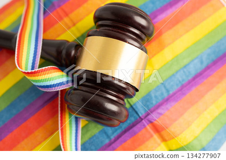 Gavel for judge lawyer on rainbow flag, symbol of LGBT pride month. Gavel for judge lawyer on rainbow flag, symbol of LGBT pride month. 134277907
