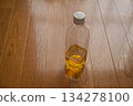 A half-drunk plastic bottle of tea 134278100