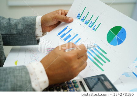 Asian business woman working with financial graph. 134278190