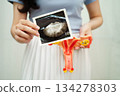 Uterus ultrasound, Asian woman holding human anatomy model. 134278303