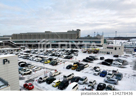 Snow-covered parking lot B at Hokkaido New Chitose Airport with the domestic terminal in the background Snow-covered parking lot B at Hokkaido New Chitose Airport with the domestic terminal in the background 134278436