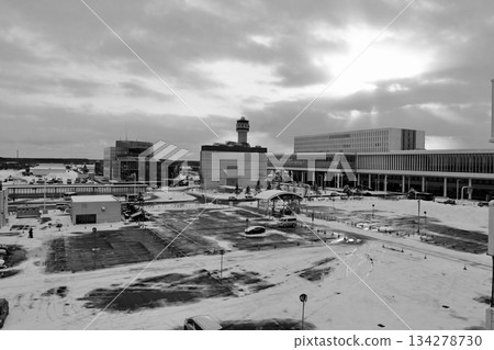 "Hokkaido New Chitose Airport" Parking Lot B "Black and White" with snow piled up with the international terminal in the background "Hokkaido New Chitose Airport" Parking Lot B "Black and White" with snow piled up with the international terminal in the background 134278730