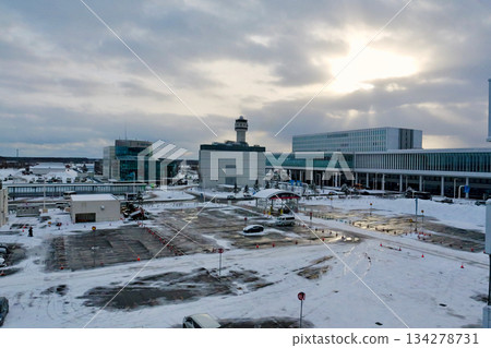 Snow-covered parking lot B at Hokkaido New Chitose Airport with the international terminal in the background Snow-covered parking lot B at Hokkaido New Chitose Airport with the international terminal in the background 134278731