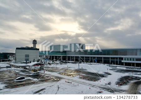 Snow-covered parking lot B at Hokkaido New Chitose Airport with the international terminal in the background Snow-covered parking lot B at Hokkaido New Chitose Airport with the international terminal in the background 134278733