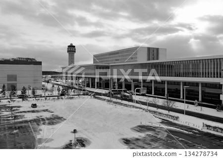 "Hokkaido New Chitose Airport" Parking Lot B "Black and White" with snow piled up with the international terminal in the background "Hokkaido New Chitose Airport" Parking Lot B "Black and White" with snow piled up with the international terminal in the background 134278734
