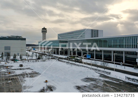 Snow-covered parking lot B at Hokkaido New Chitose Airport with the international terminal in the background Snow-covered parking lot B at Hokkaido New Chitose Airport with the international terminal in the background 134278735