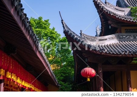 Chinese red lantern on Longhua temple roof ceiling with blue sky, Shanghai 134279054