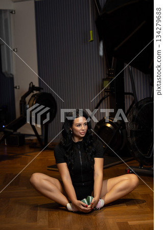 A girl is doing stretching exercises in the gym. A girl is doing stretching exercises in the gym. 134279688