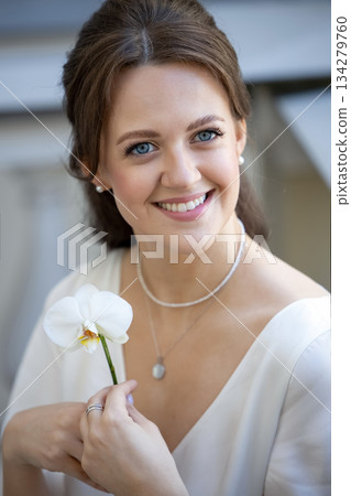 Bride holding white orchid flower Bride holding white orchid flower 134279760